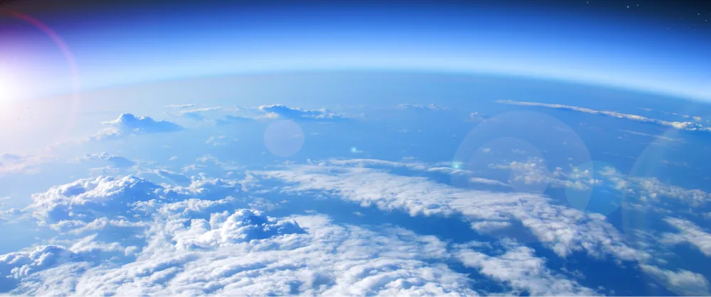 Satellite view of Earth from space showing cloud formations over the ocean, illustrating the impact of atmospheric changes on global warming